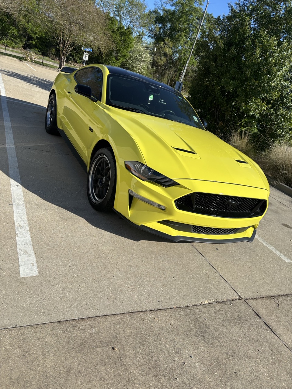Glossy yellow Ford Mustang with a showroom finish